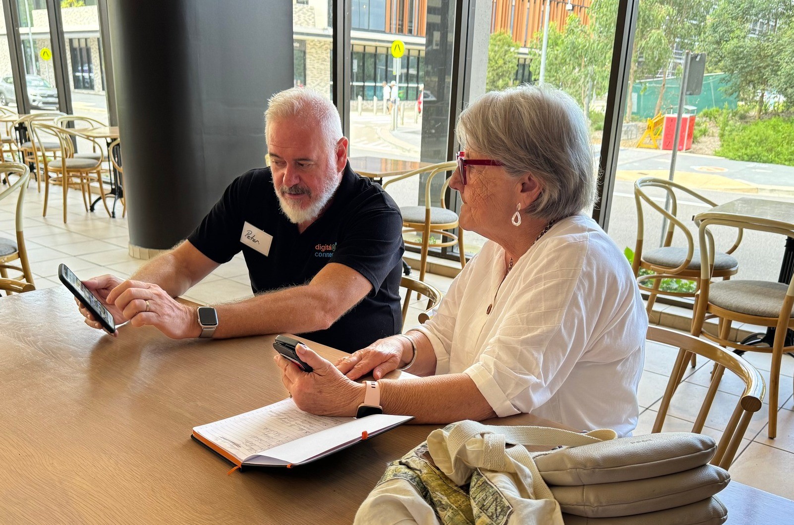 Digital Mentor assisting a lady with her smartphone